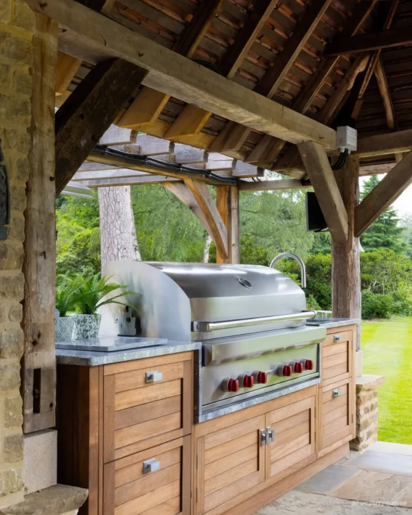cocina exterio con parrilla empotrada en terraza rustica